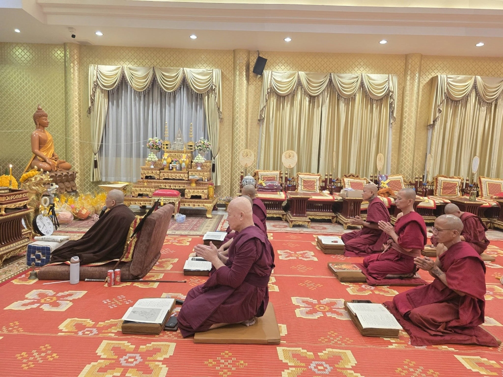 คณะสงฆ์นั่งสวดมนต์ทำวัตรเย็นพร้อมเปิดบทสวดมนต์อย่างพร้อมเพรียง